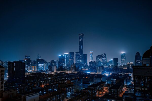A city skyline at night with lights on.