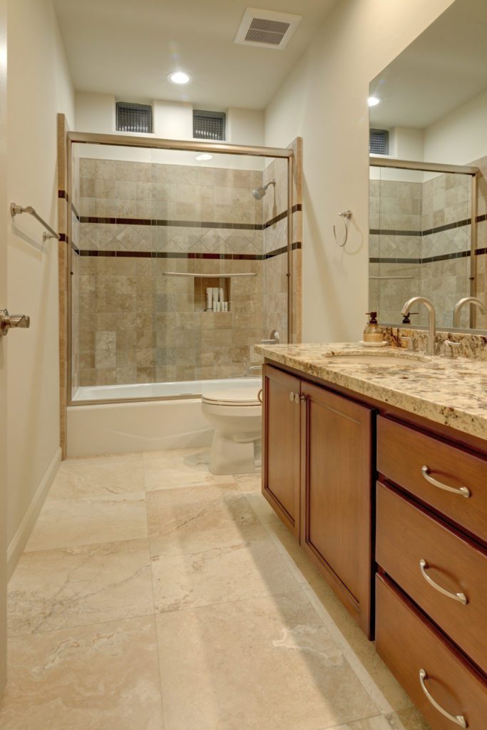 A bathroom with marble floors and walls.