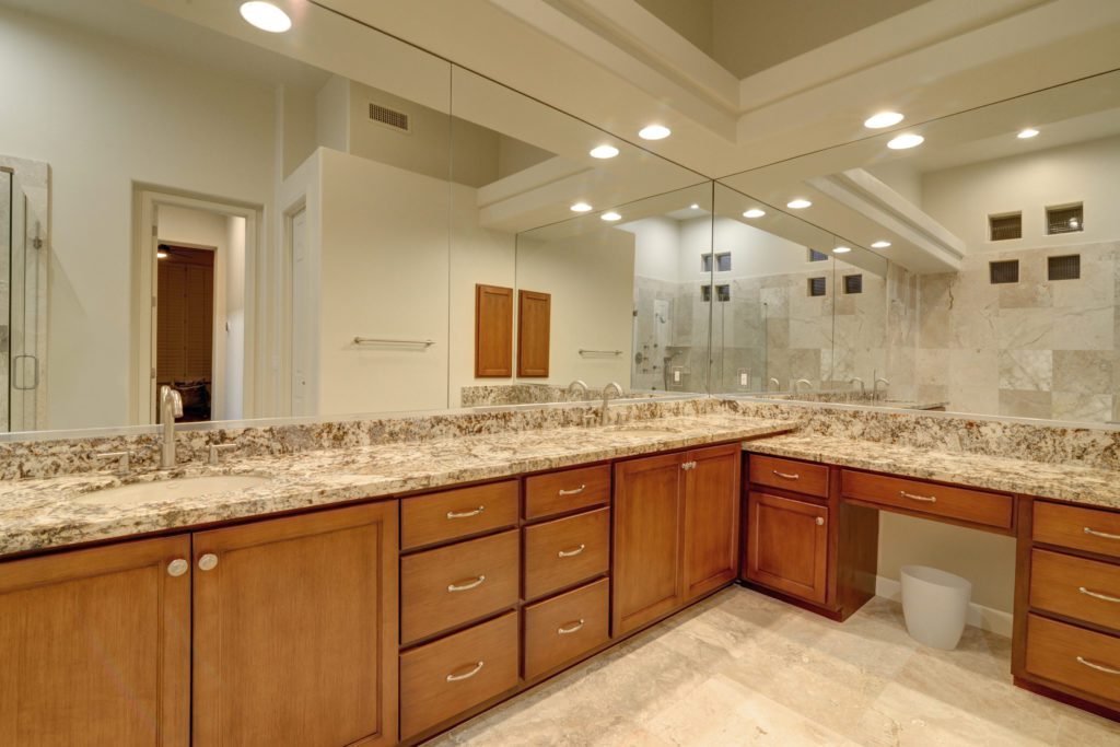 A large bathroom with two sinks and a mirror.