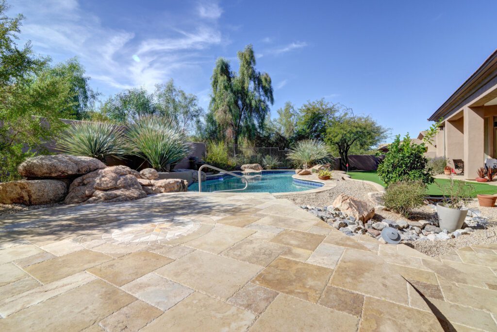 A pool with a rock garden and a swimming pool.