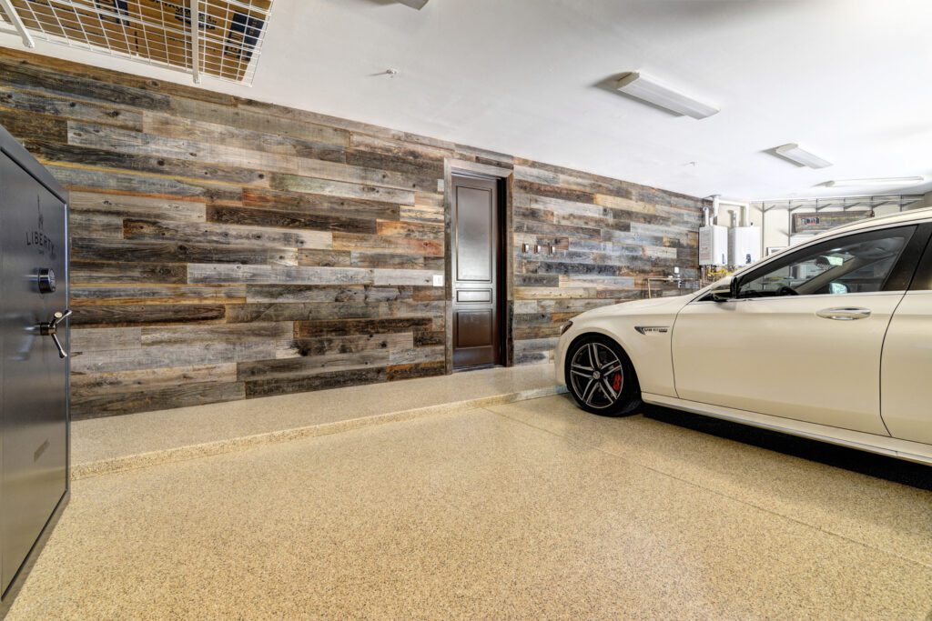 A car parked in the garage with a wooden wall.