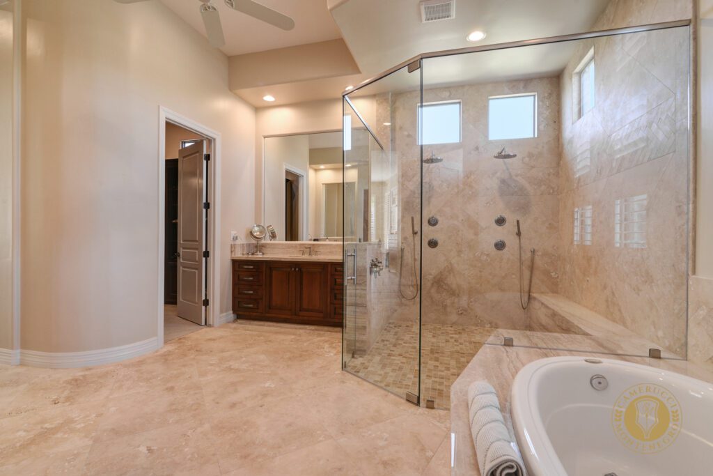 A large bathroom with a glass shower and a jacuzzi tub.