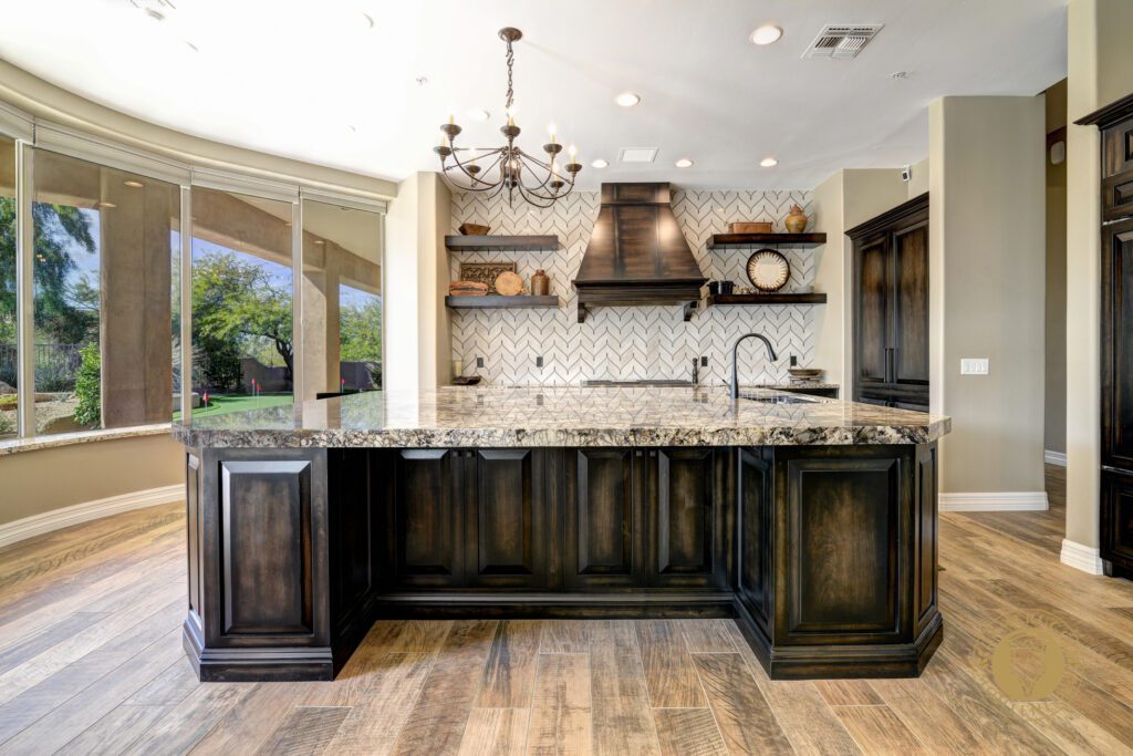 A kitchen with wooden floors and marble counter tops.