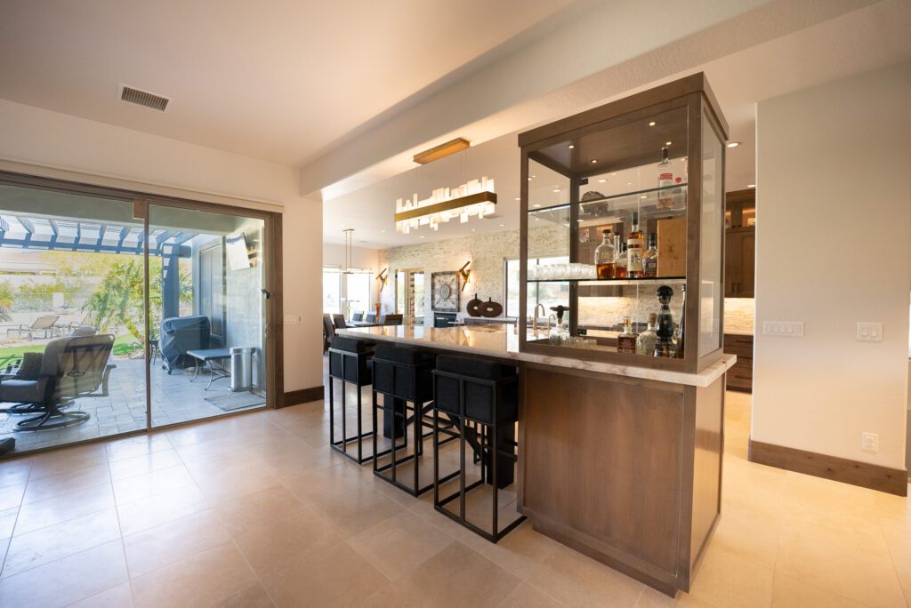 A kitchen with a bar and stools in it