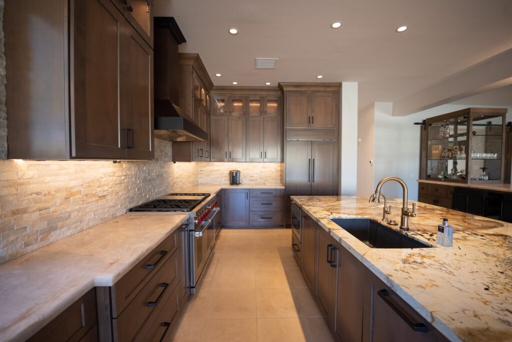 A kitchen with brown cabinets and white counters