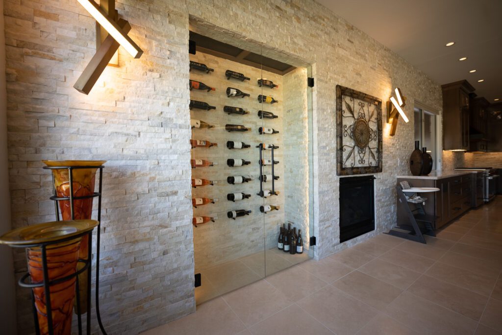 A room with a wine cellar and a fireplace.