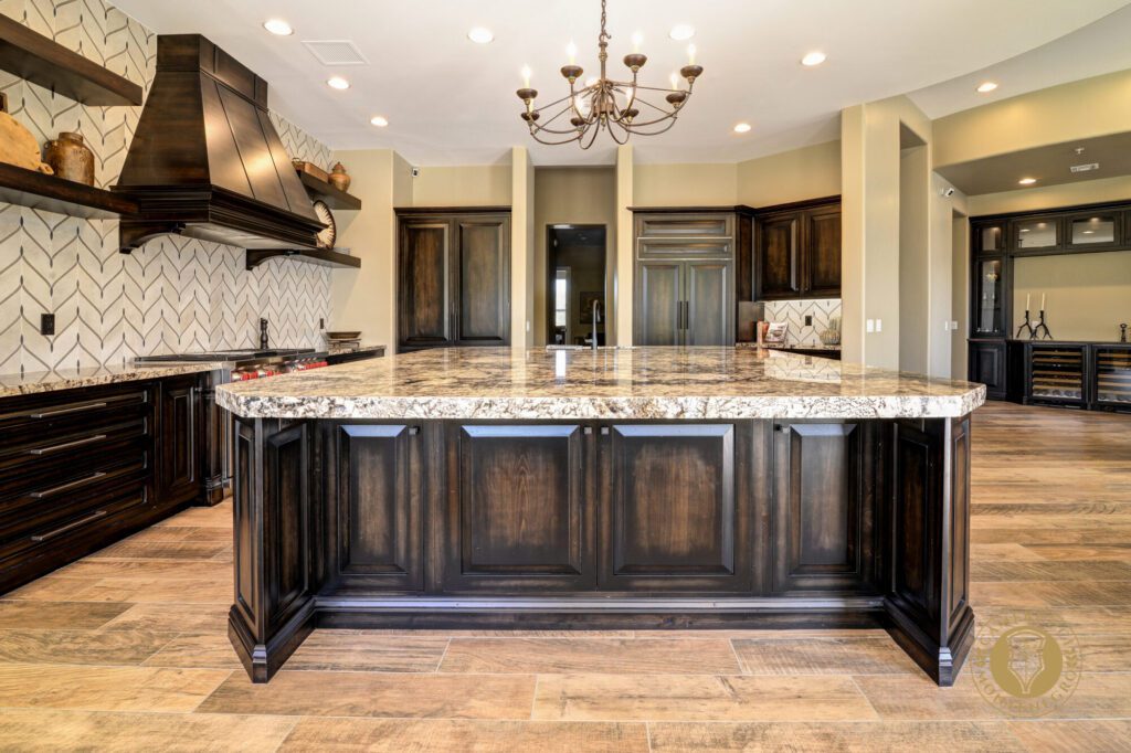 A large kitchen with a marble counter top and wooden cabinets.
