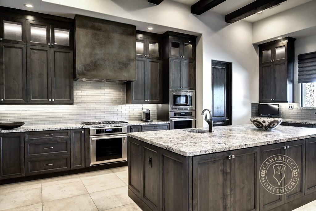 A kitchen with dark wood cabinets and white counters.