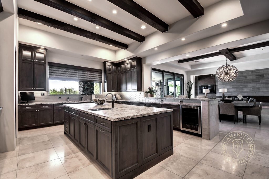 A large kitchen with dark wood cabinets and white counters.