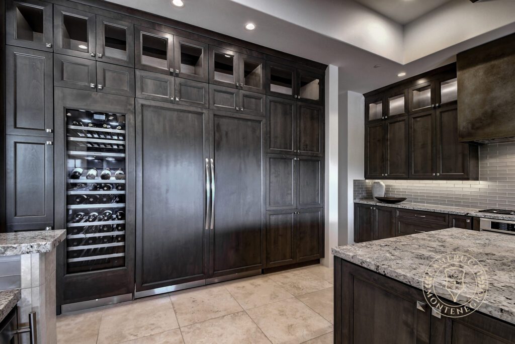 A kitchen with dark wood cabinets and granite countertops.