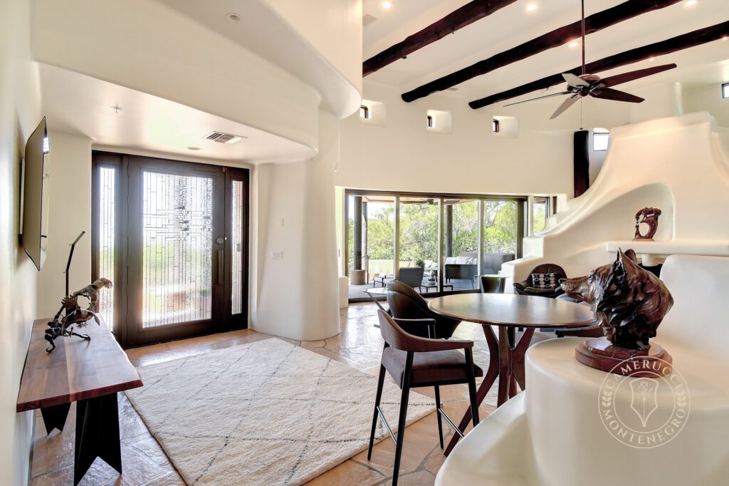 A living room with a table and chairs in it