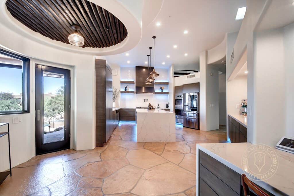 A kitchen with a large island and a lot of counter space.